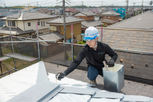 屋根の塗装作業をしている作業員