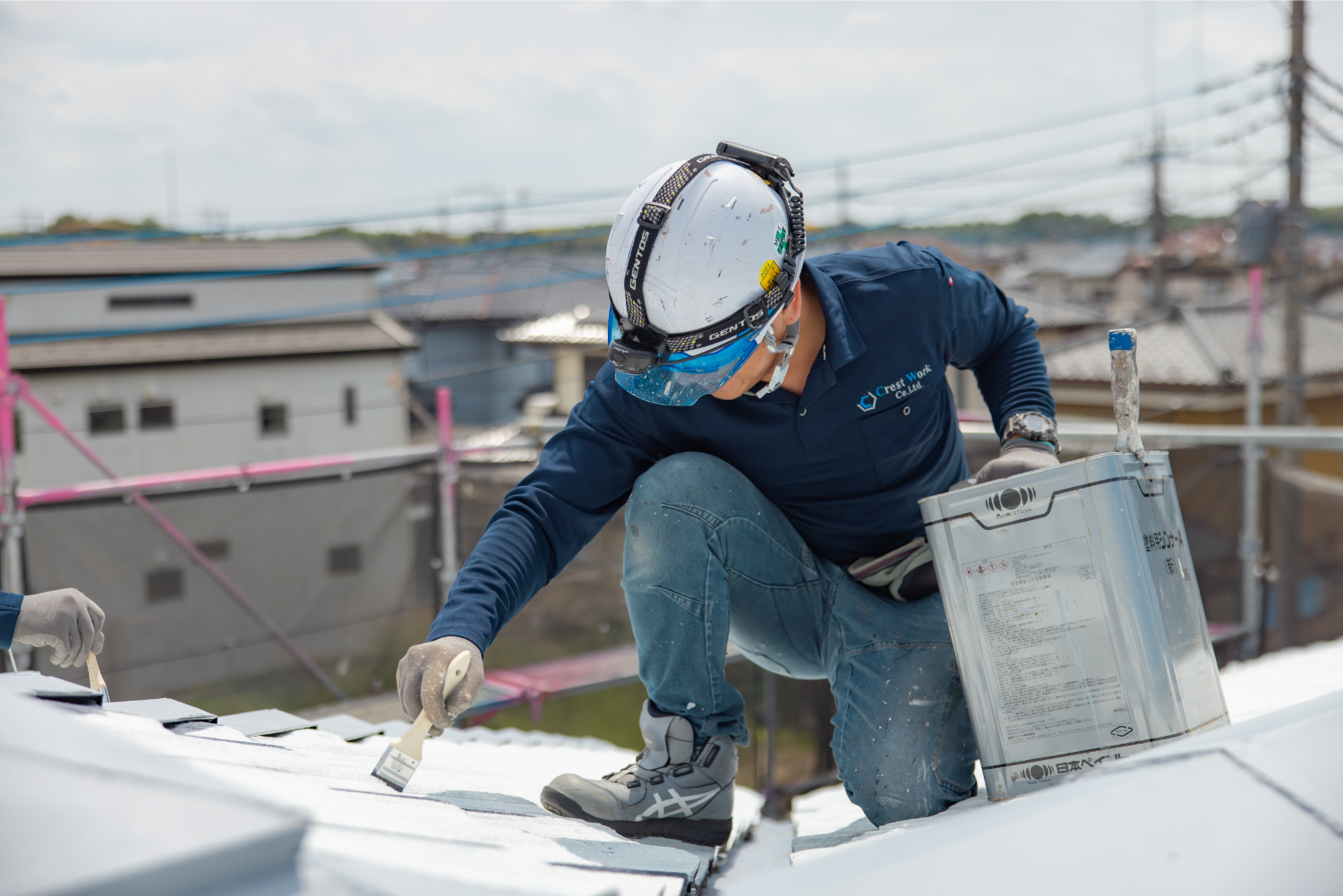 屋根塗装中の作業員